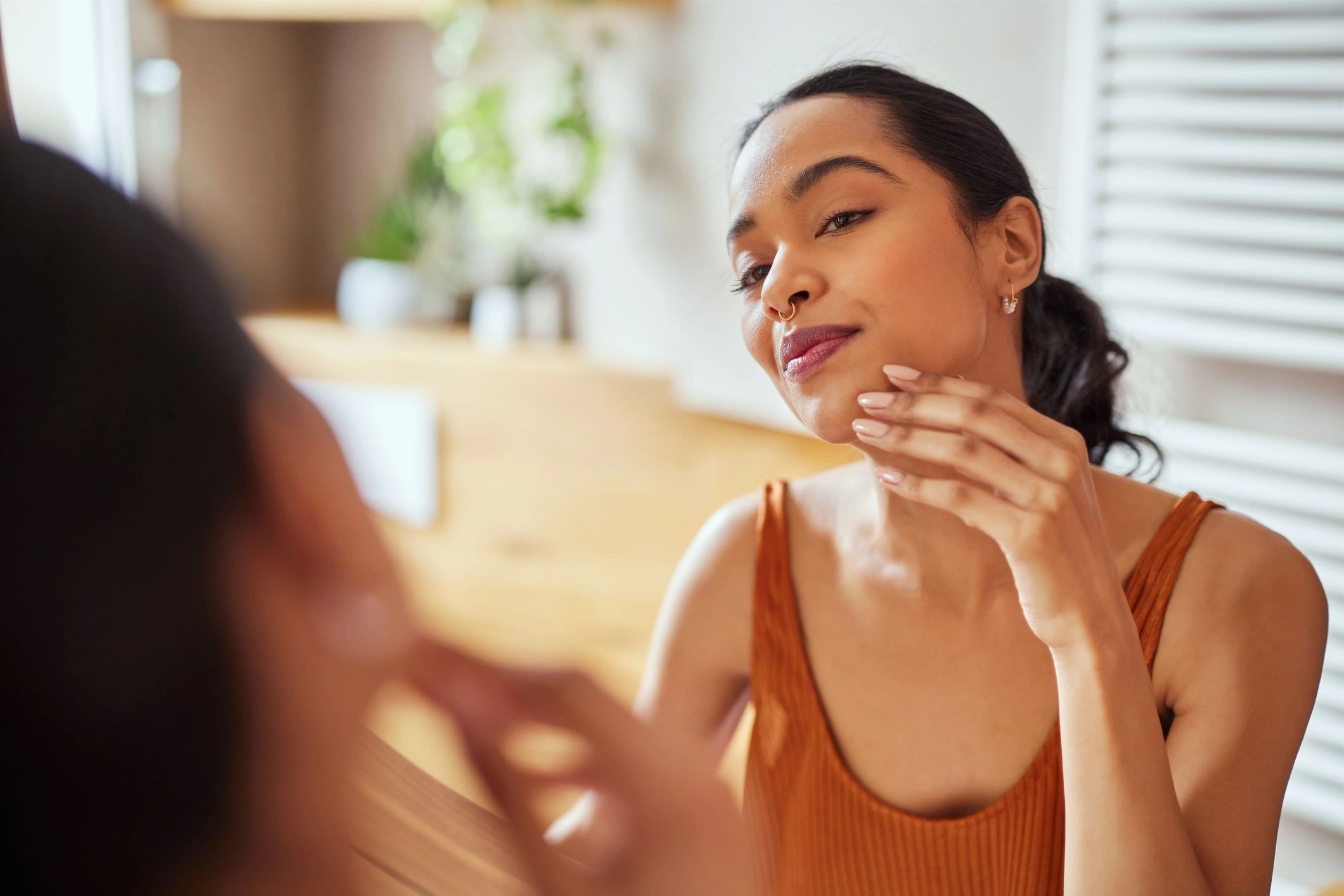 Woman looking in the mirror during a quiet morning routine